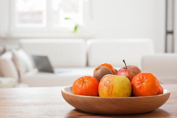 Fruit bowl in a bright living room with laptop on a couch