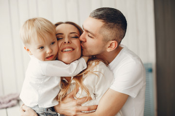 Family at home. Little girl with her brother. Mother and father with children