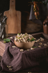 Bowl with pistachios on a rustic background