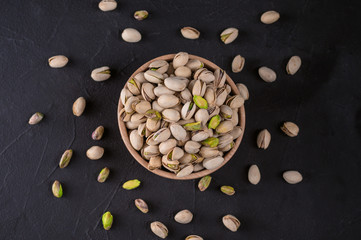 Bowl with pistachios on a rustic background