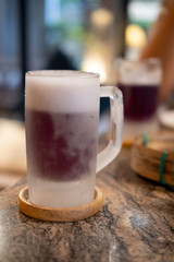 Mug of purple cold beer.