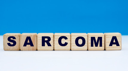 concept word sarcoma on cubes on a blue background