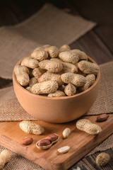 Peanuts in shells on wood background