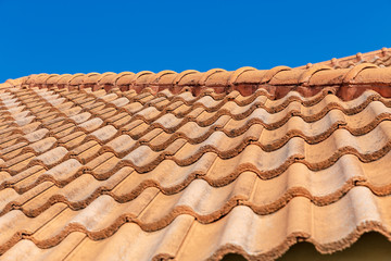 Close up of brown clay roof tiles. Red old dirty roof. Old roof tiles. Construction equipment build a house.
