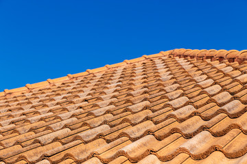 Close up of brown clay roof tiles. Red old dirty roof. Old roof tiles. Construction equipment build a house.