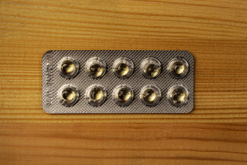 Close-up of a selection pill, tablet & capsule against a  wood background, medicine