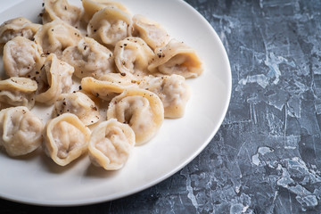 Pelmeni Russian national kitchen. Boiled dumplings with beef. Selective focus. Shallow depth of field.