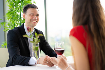  husband and wife having a lunch at restaurant in valentine's day