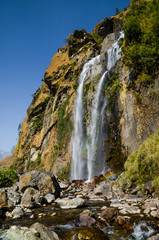 Fototapeta na wymiar Waterfall in Tal village in Marshyangdi river valley. Annapurna circuit trek, Nepal.