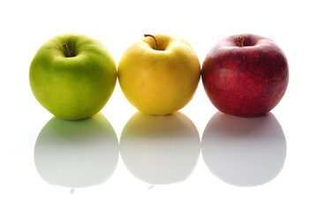 Apples green, yellow and red on a white background.