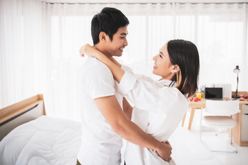 Portrait of Asian lovely couple close up. Couple in bedroom with natural lighting from window.