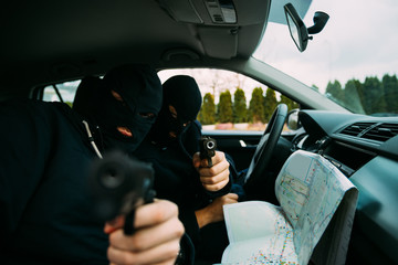 Gangster pointing with their guns at the camera.