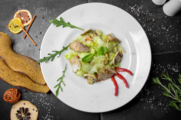 Caesar salad on a black decorative background