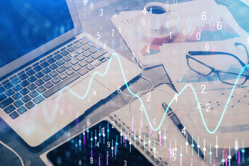 Forex market graph hologram and personal computer on background. Multi exposure. Concept of...