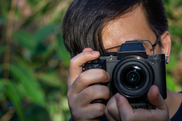 A close up asian man photographer in nature