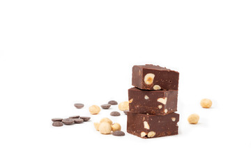 Fudge on a white plate with nuts and chocolate diced