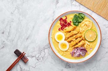 Ohn No Khao Swe on white marble background. Oh No Khao Suey is Coconut Milk Noodle Soup of myanmar...