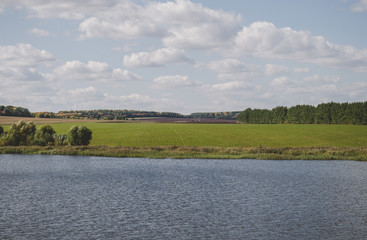 Countryside landscape with lake and field