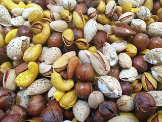 mixed nuts on black background.Many nuts, such as walnuts, cashews, macadamia nuts sold in market at Iran. Grains help Lower Cholesterol and eat healthy