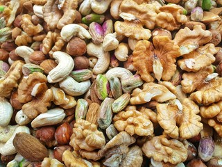 closeup of mixed nuts.Many nuts, such as walnuts, cashews, macadamia nuts sold in market at Iran. Grains help Lower Cholesterol and eat healthy