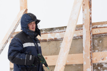 Portrait of a worker in overalls at a construction site