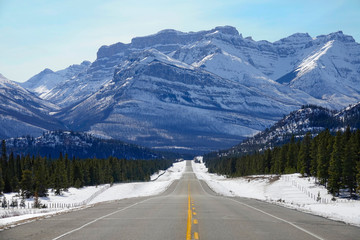 POV: Driving along a road offering a stunning view of the Canadian Rockies