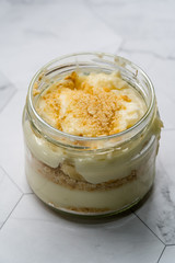 Homemade Custard Banana Pudding with Baby Biscuit Powder. Turkish Magnolia Dessert in Glass Bowl.