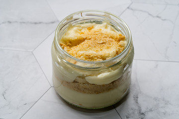 Homemade Custard Banana Pudding with Baby Biscuit Powder. Turkish Magnolia Dessert in Glass Bowl.