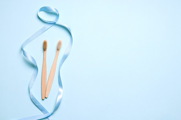 two bamboo toothbrushes on a blue background. have copy space. Horizontal Image Zero Waste Concept