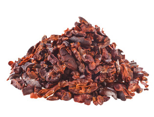Heap of cacao nibs isolated on white background.