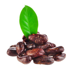 Heap of roasted cacao beans with green leaves isolated on a white background.