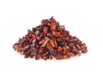 Heap of cacao nibs isolated on white background.