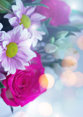 Delicate floral background with copy space under the text. Blurred background with spring flowers, bokeh. Bouquet of flowers close-up