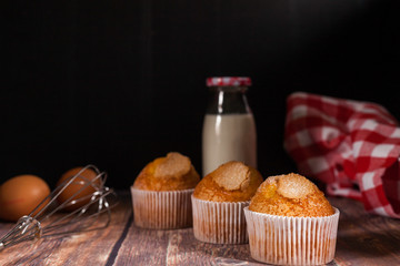 three delicious cupcakes, eggs and napkin