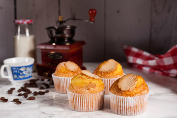 four delicious cupcakes and grinder coffee