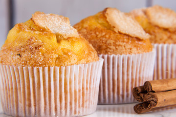 three delicious cupcakes close-up and cinnamon