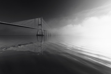 Vasco da Gama cable-stayed concrete bridge, over the river Tagus, on an early foggy winter morning, Black and White Photo, Lisbon, Portugal