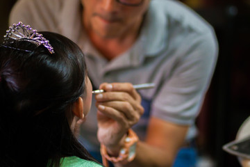 Fototapeta premium Kids do make-up by Beautician