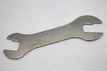 unusual metal wrench on a gray background