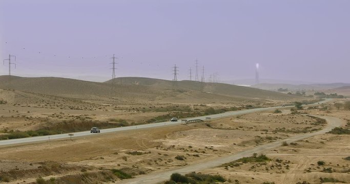 One car moves along a highway in desert at winter