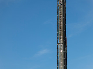 Detail of a radio station transmission tower on a blue sky background