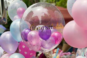 tranparent congratulation balloons on street. celebrate balloon gift.
