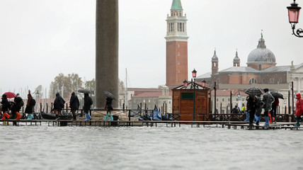 People walking on the footbridge in Venice