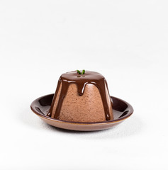 Italian dessert Panna cotta with chocolate sauce on a light background