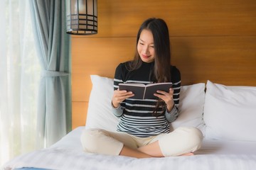 Obraz na płótnie Canvas Portrait young asian woman read book in bedroom