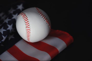 American traditional sports game. Baseball. Concept. Baseball ball and bats on a table with american flag.