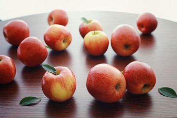 Fresh apples on a wooden board. Harvest of red apples. Fruits and cinnamon on the table.