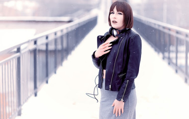 Obraz premium Girl in headphones listening to music outdoors