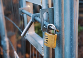 Steeldoor with lock with blurred garden in the background