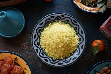 Bulgur porridge in a painted Eastern plate in the center of the table Mandarin dried apricots Eastern cuisine